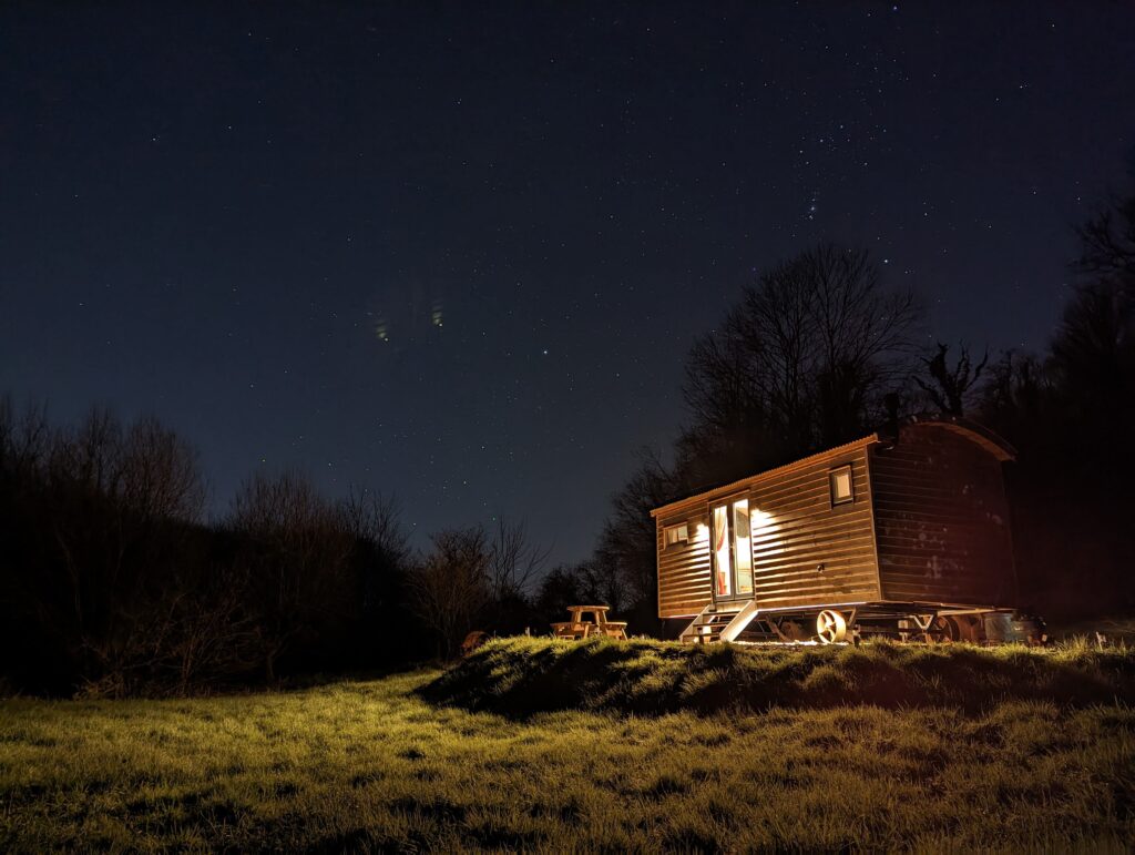 Meidrim Meadows shepherds hut set in a romantic glow under the dark skies of Carmartheshire, West Wales. 